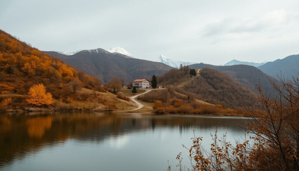 A serene autumn landscape in Montenegro during the off-season. In the foreground, a tranquil mountain lake reflects the muted hues of the surrounding foliage - golden leaves, russet underbrush, and the distant peaks capped with a dusting of fresh snow. The moody skies above are a soft shade of grey, casting a gentle, diffused light across the scene. In the middle ground, a winding dirt path leads the eye towards a quaint village, its charming stone houses and red-tiled roofs nestled amidst the rolling hills. An air of quietude and solitude pervades the atmosphere, inviting the viewer to pause and take in the beauty of Montenegro in its off-season splendor.
